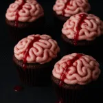 Halloween brain cupcakes with raspberry sauce